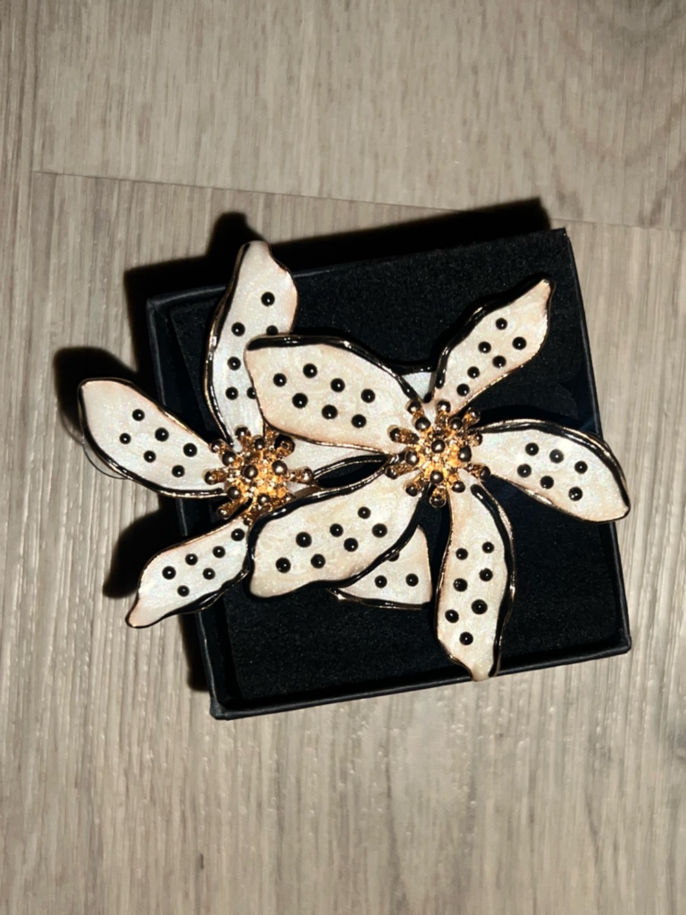 Gold-Trim White Floral Drop Earrings with Black Dot Accents